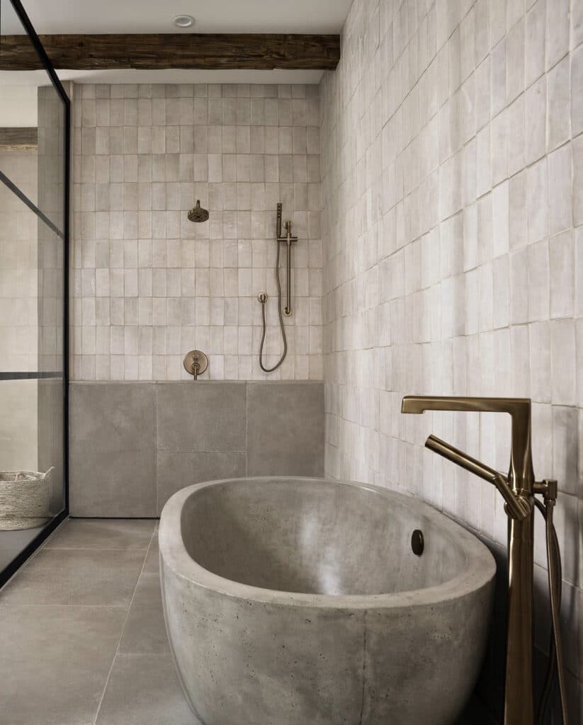 Concrete tub with zellige tile bathroom