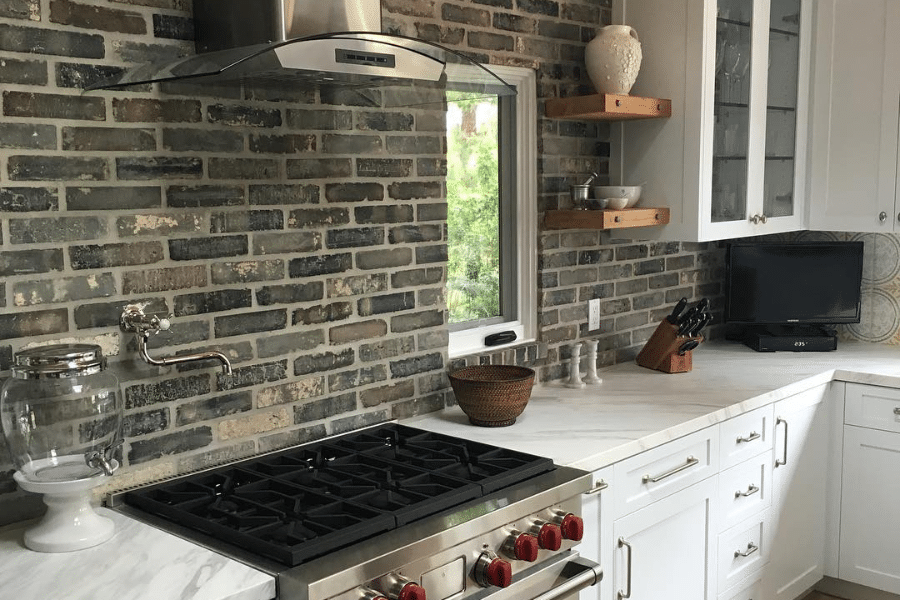 grey brick backsplash in a white kitchen